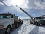 The pole and other pieces were transferred to a smaller, heavier truck to get them through the snow.