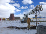 Meanwhile, an auger attacked the job of drilling a hole in the ground.