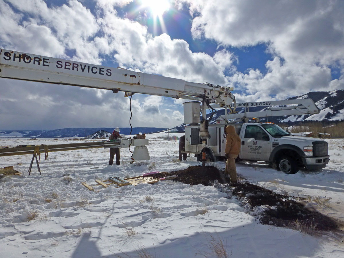 Fighting the rocks, the auger finally made the hole deep enough.